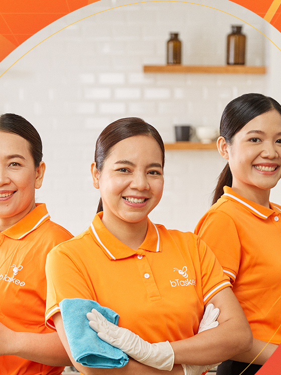 bTaskee Taskers smiling together in orange uniform